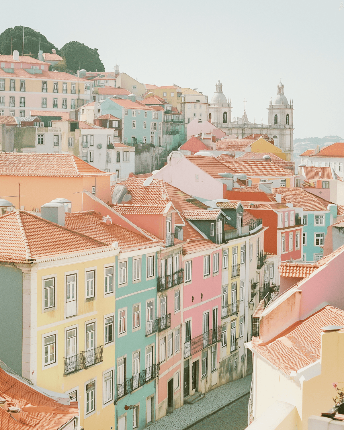 Pastel coloured historic buildings with terracotta roofs in a European city